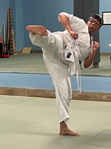 A student demonstrates a side kick