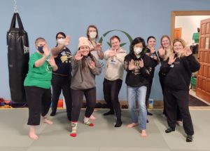 Young Adult Self-Defense Students Demonstrate Their Strength